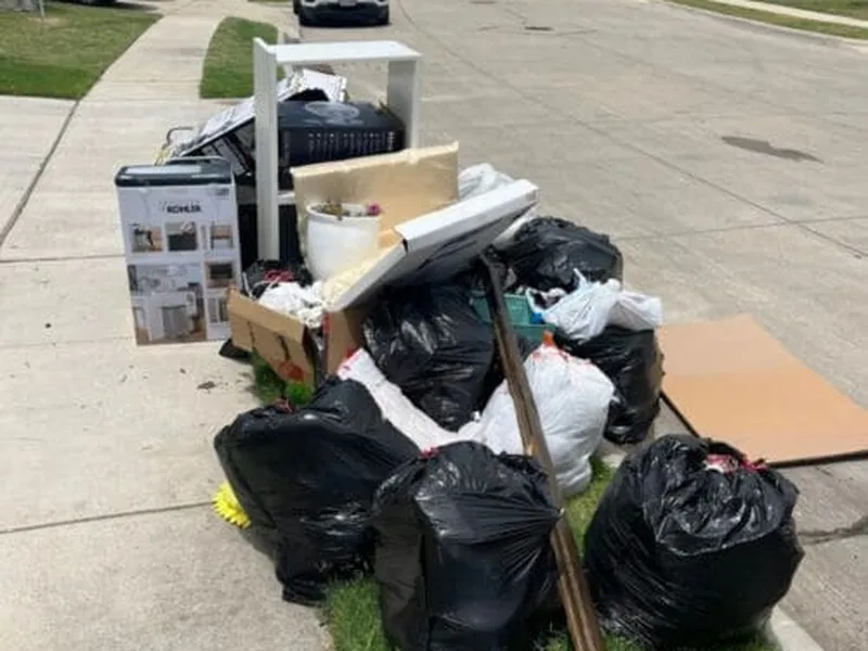 Bags and boxes staged at the curb for Freedom Junk Removal pickup