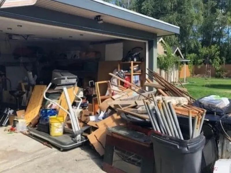 Garage packed with boxes and stored items during a house cleanout