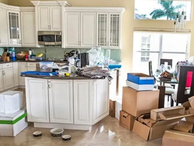 Kitchen with cabinets and countertops cleared during a house cleanout